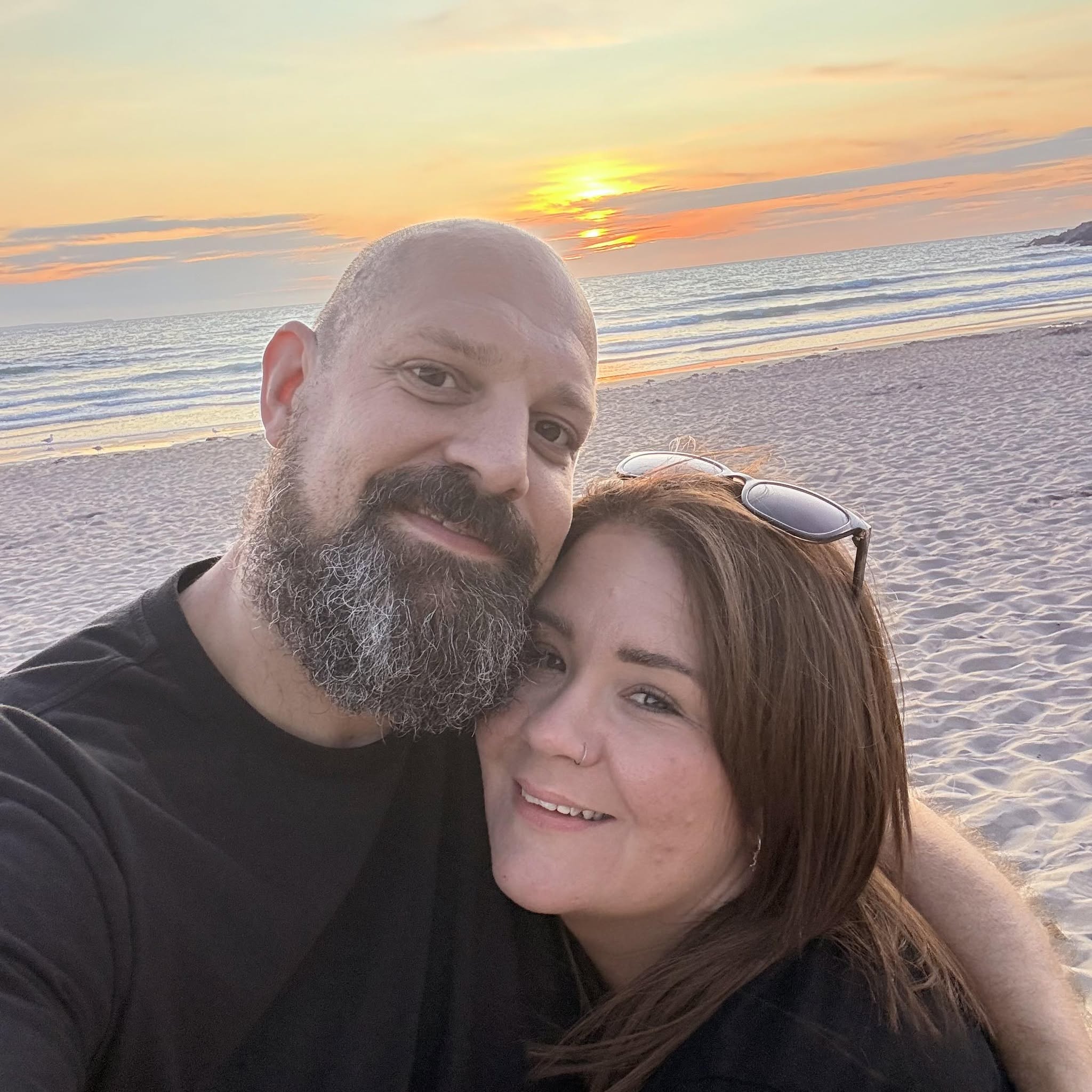 Rob and Lucy together on the beach at golden hour